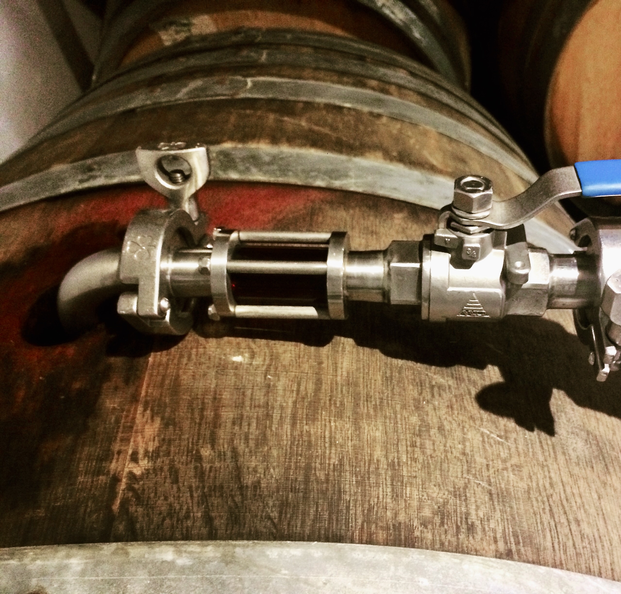 Racking wand on barrel in cellar